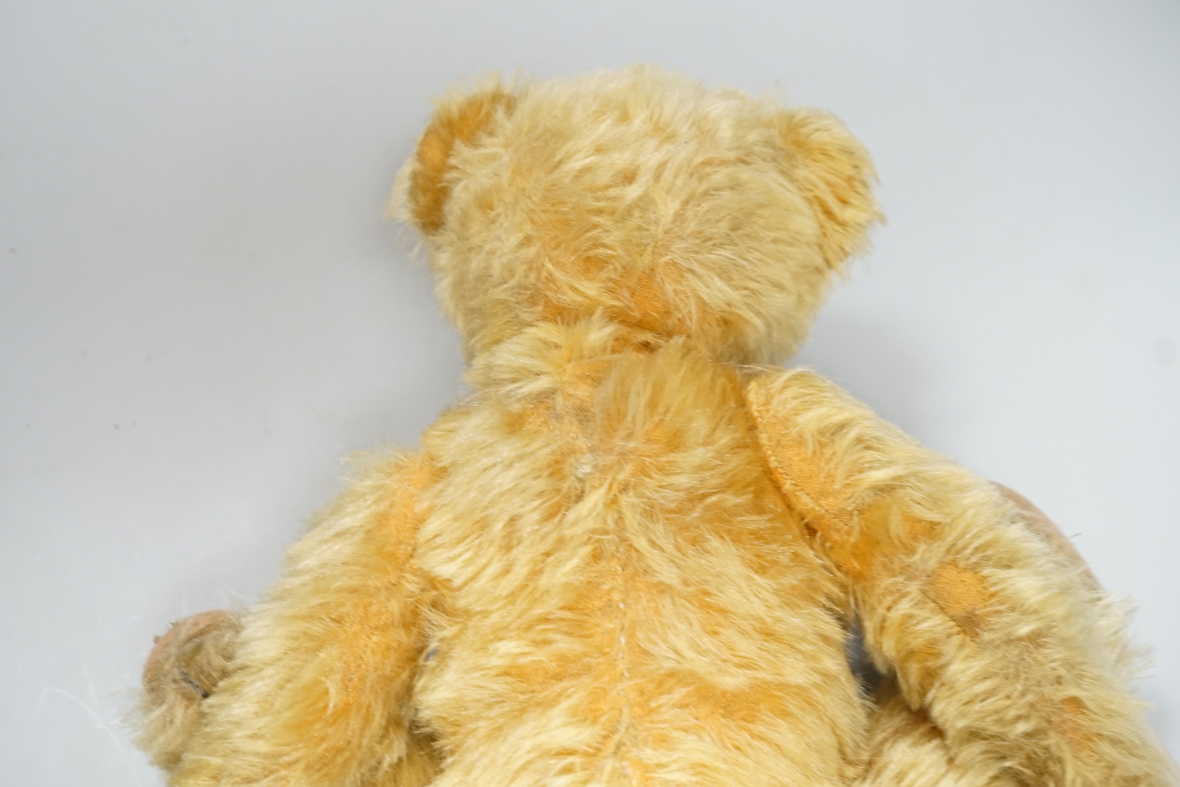 A Deans 1950's mouse eared bear, label on left foot, 16in., repair to paw pads, good mohair